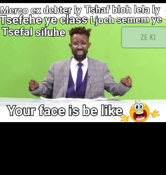 a man in a suit sitting at a desk with his hands up